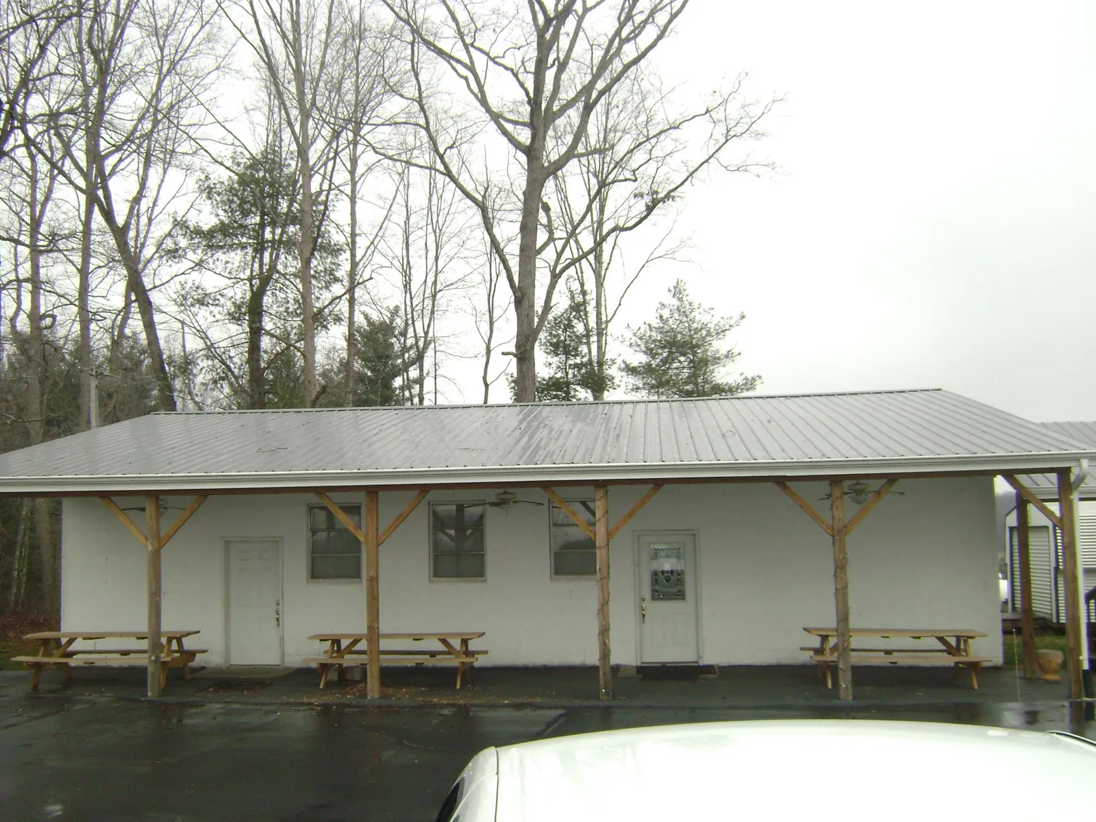 Gray metal roof over a block building with a timber post porch in Clarkston